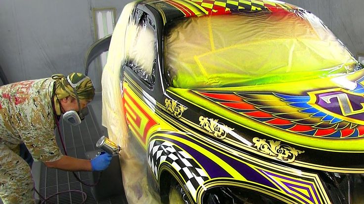 Paint tech doing custom paint to a car